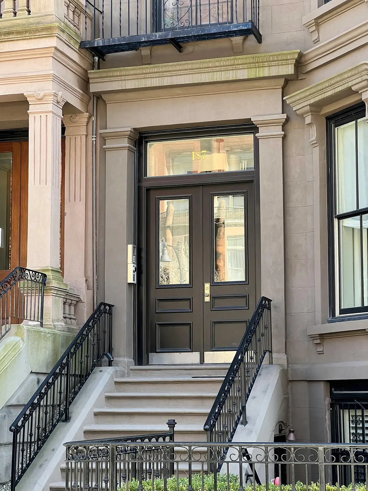 A stone stoop of a building in an up and coming NYC neighborhood