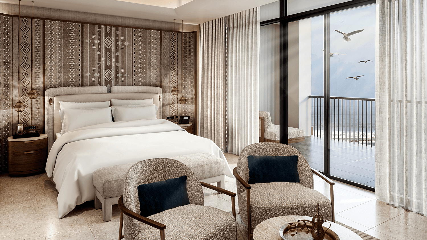 Bedroom with sitting area facing a window with balcony