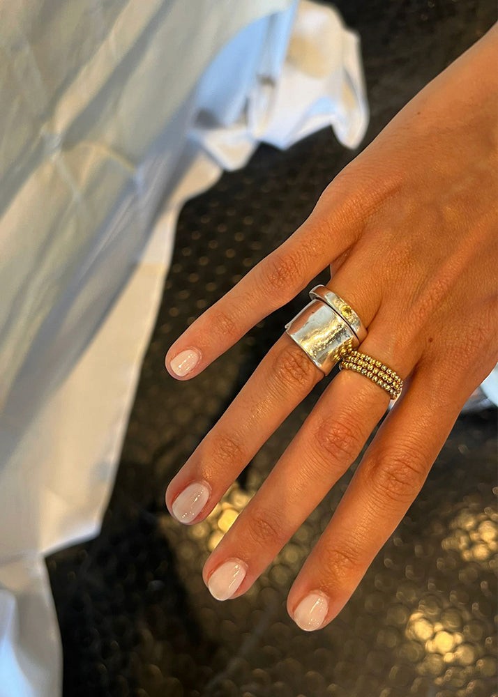 Women wearing silver ring with yellow stone