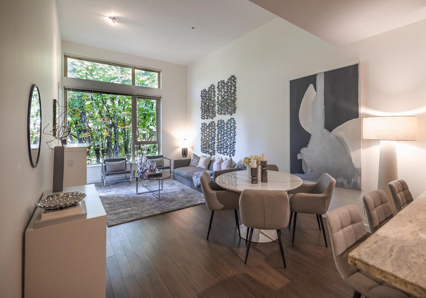 Cozy interior space featuring a living area, dining table, and large windows with natural light.