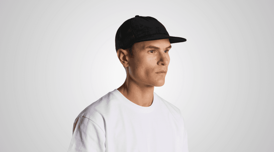 A model wearing a black cotton trucker hat
