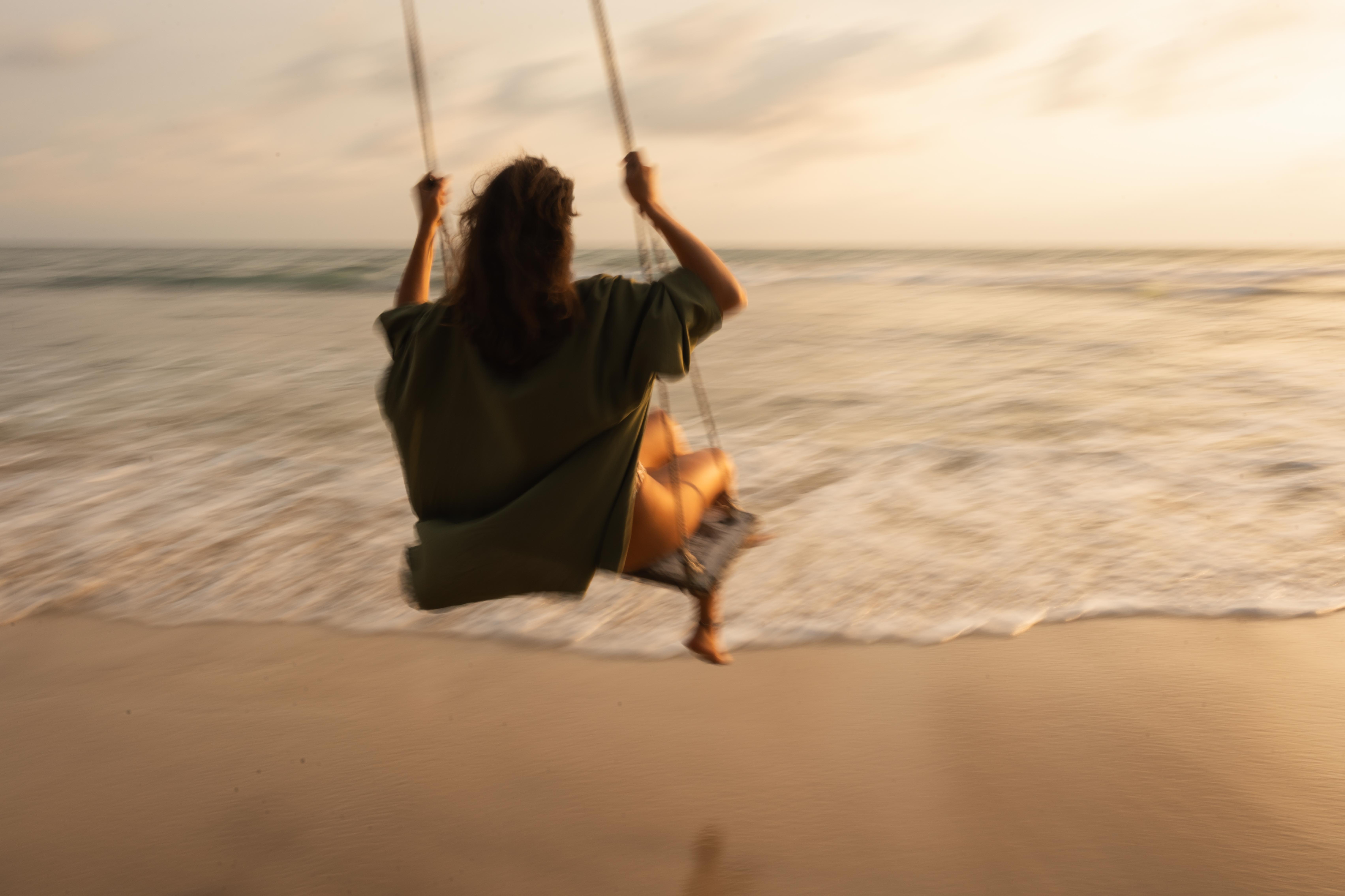 Girl on a swing at the beach 