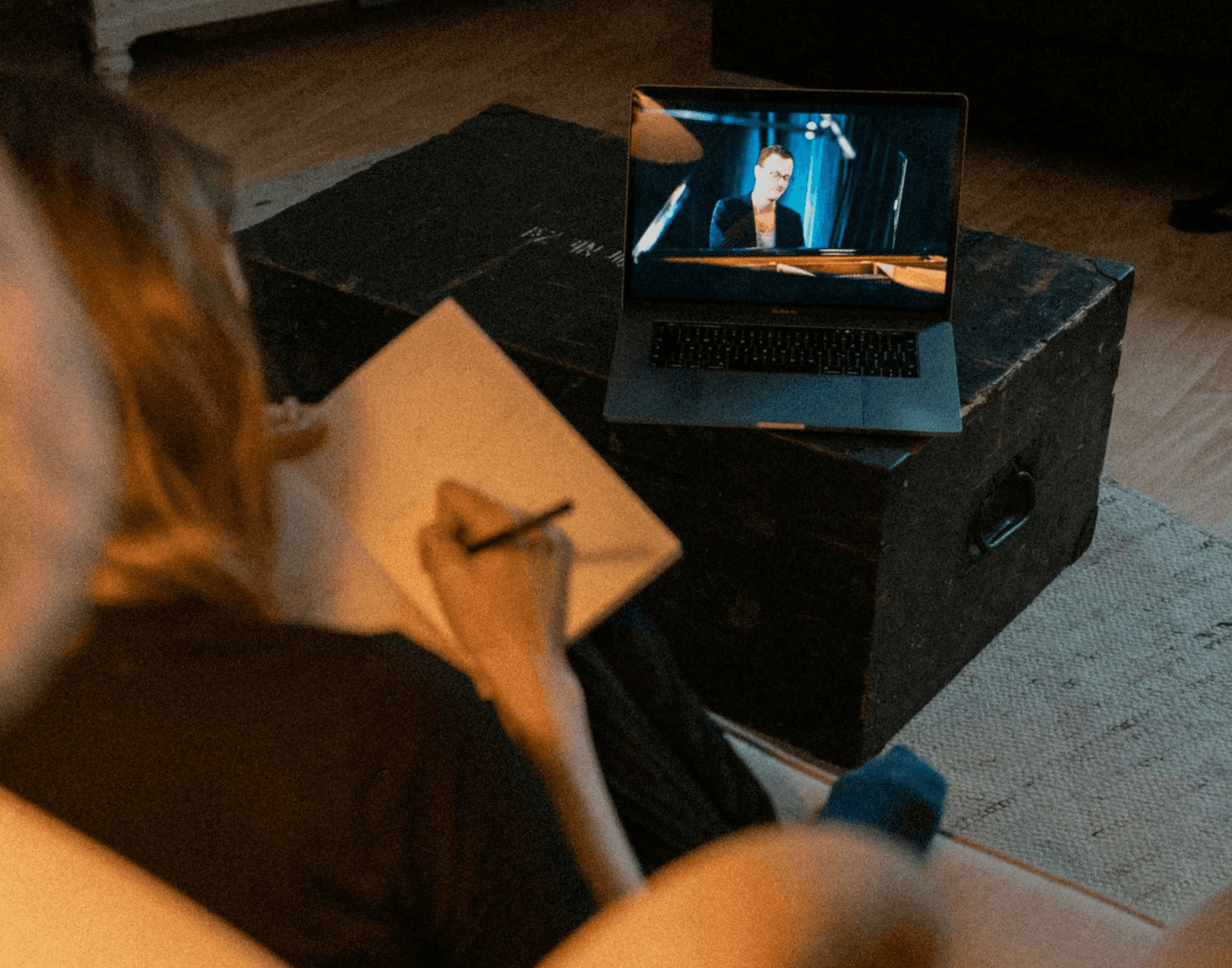 Woman watching an online course and taking notes