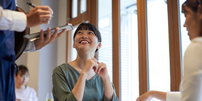 A Malaysian customer happily talking to an F&B staff