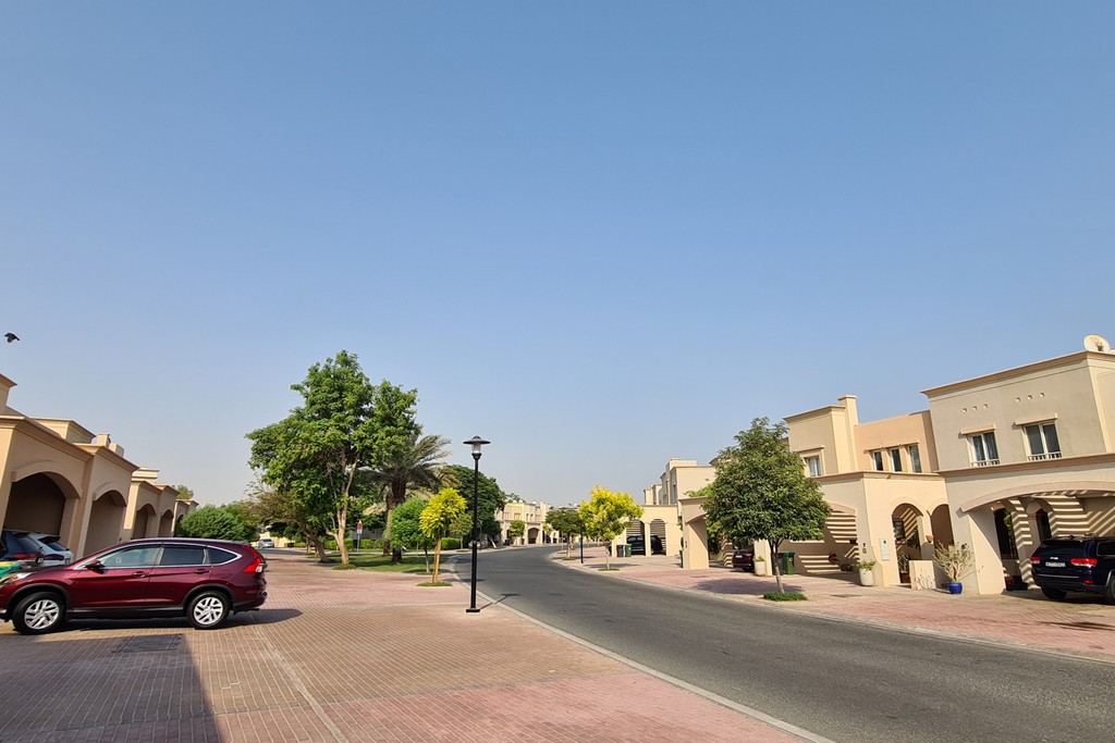 A prominent house featuring a parked car in front, noted as "Springs 15."