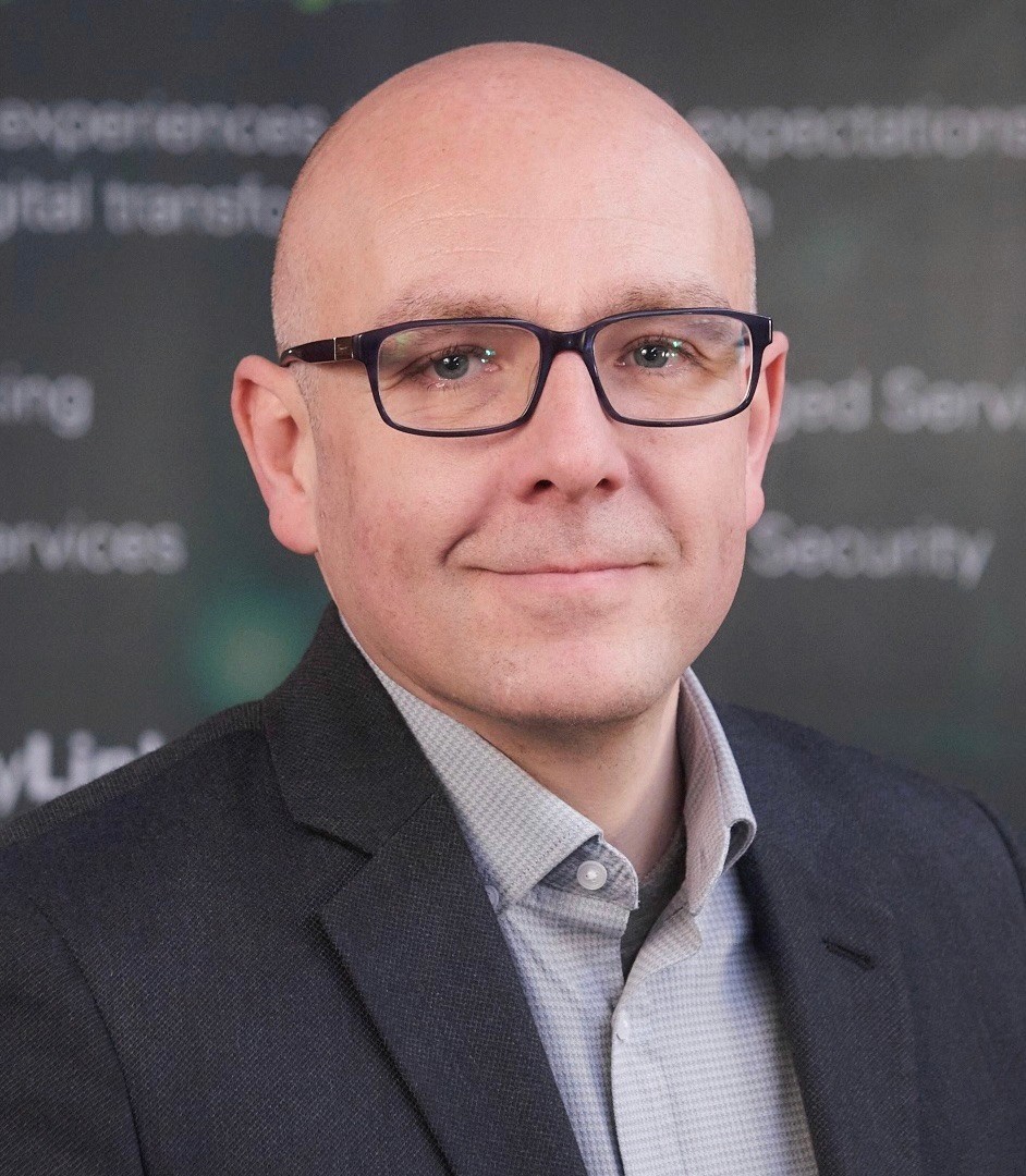 a man in a suit posing for a picture