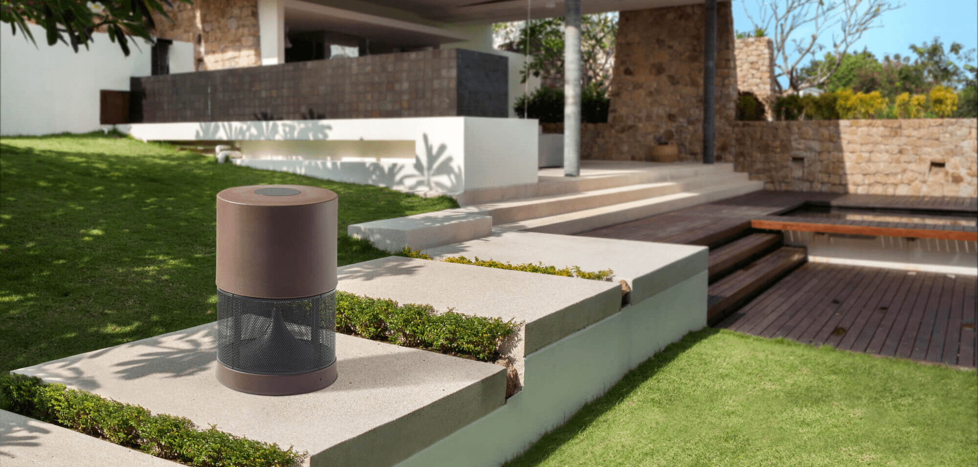 Brown cylindrical garden speaker on patio steps.