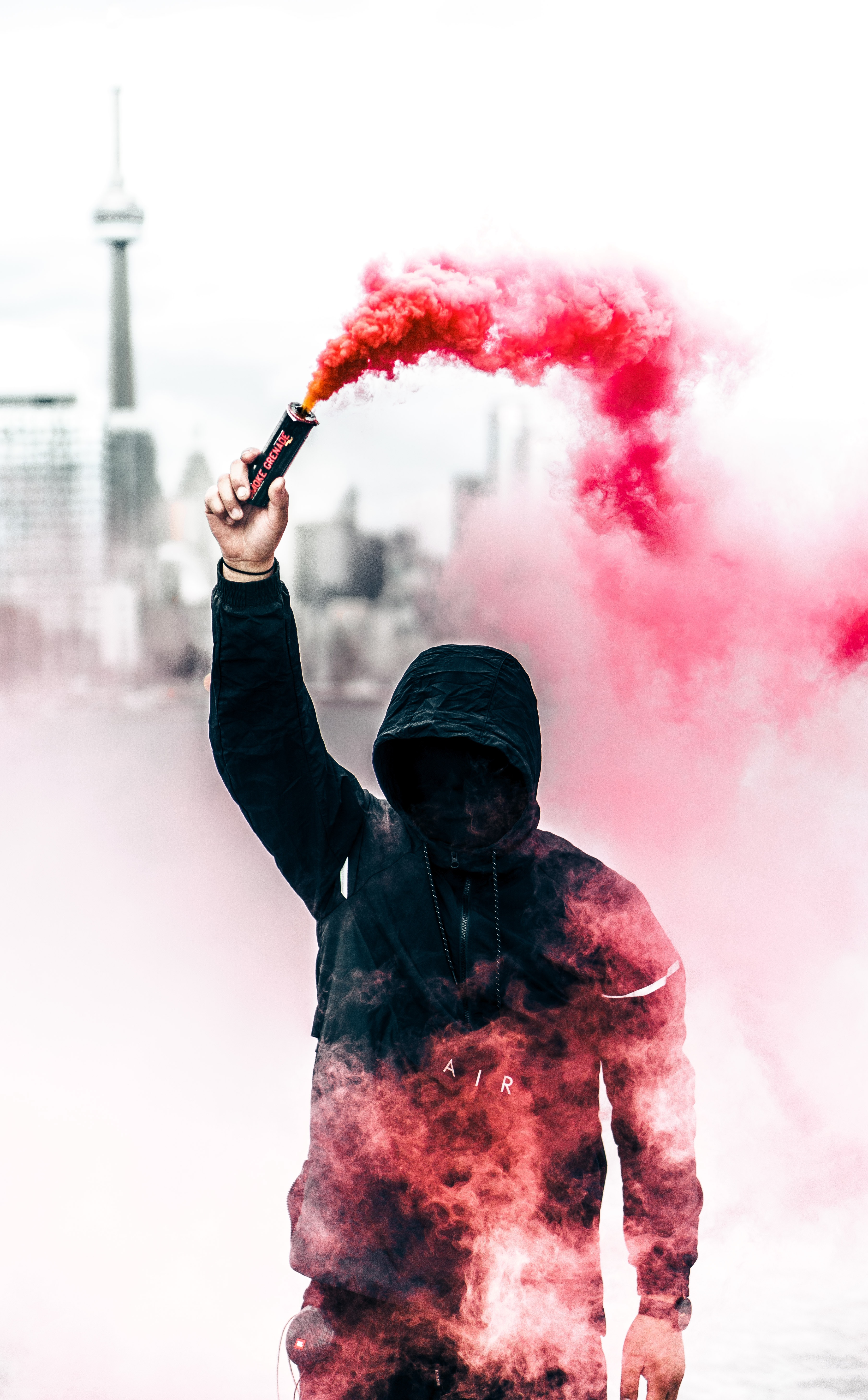 Man creating a red smoke show for his text to singing concert