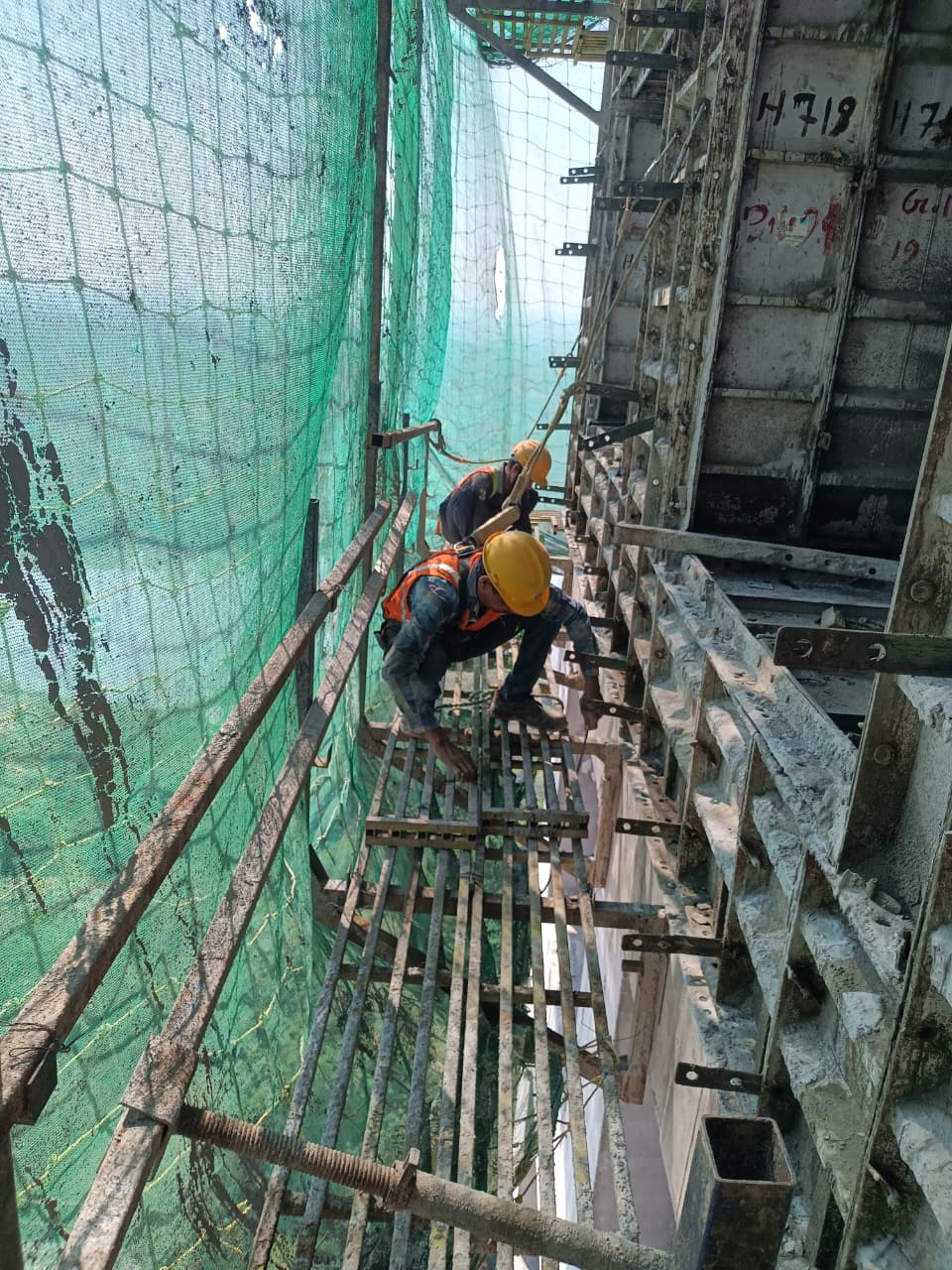 worker is installing Safety net at high-rise construction site in Pune
