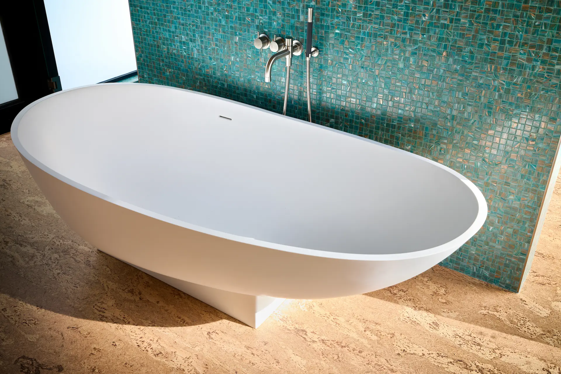 Close-up of the master bathroom's free-standing tub, a centerpiece that adds a touch of modern luxury to the Eichler home's design. Photo by Todd Huge.