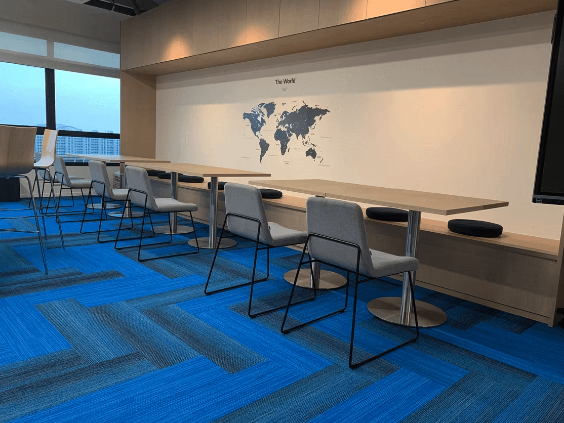 a room with a table, chairs, and a partition