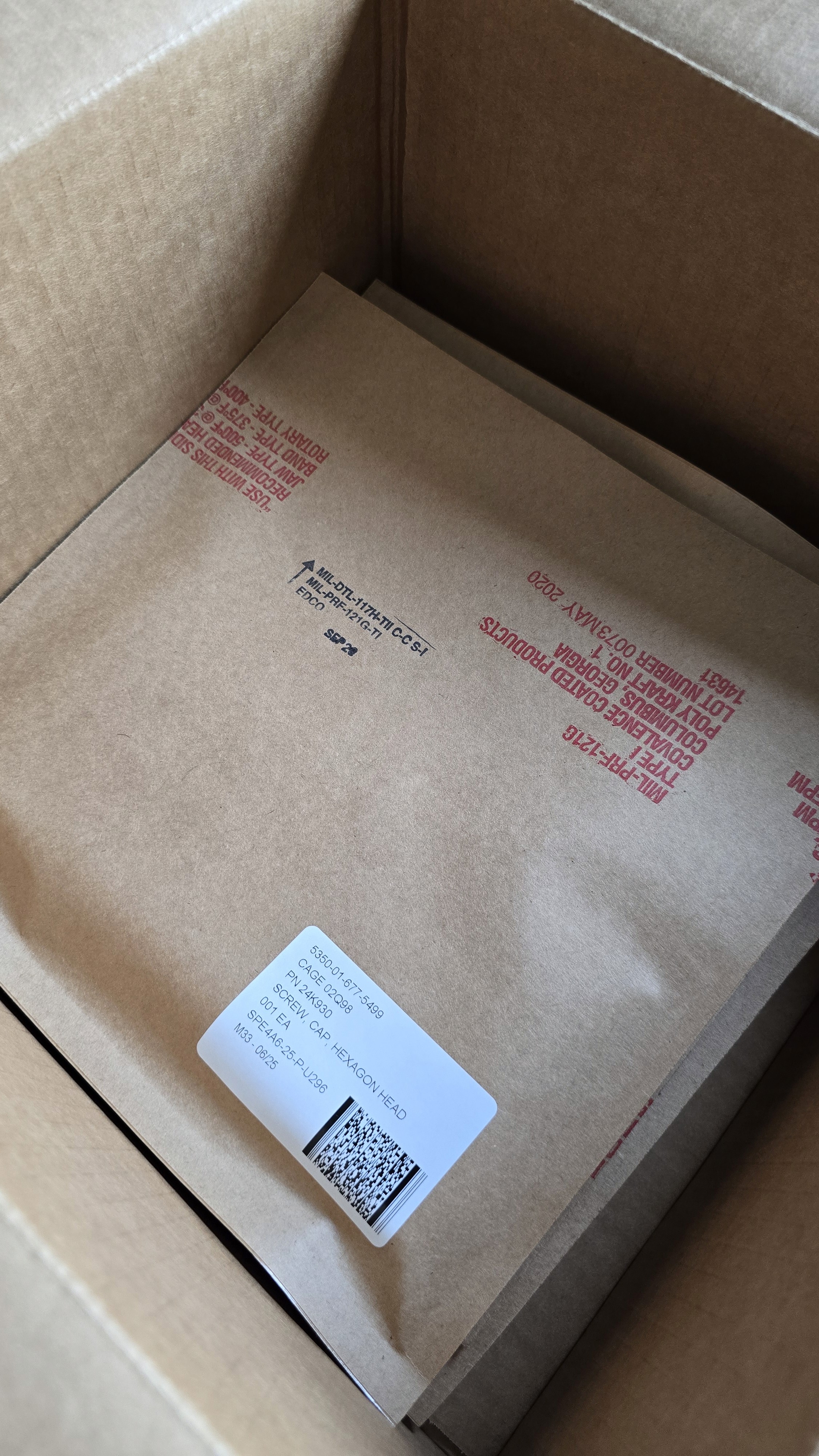 Smiling young woman with long hair standing against a dark green background, holding a finger to her chin.