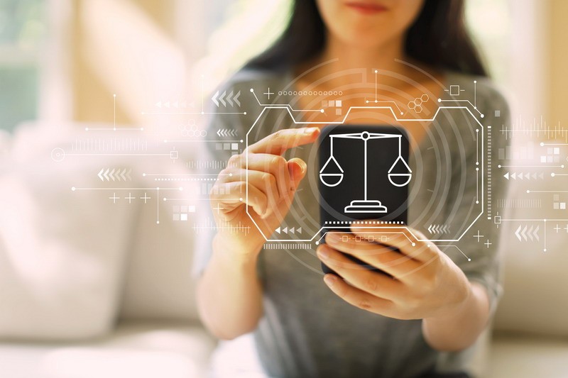 Justice theme with woman using a smartphone