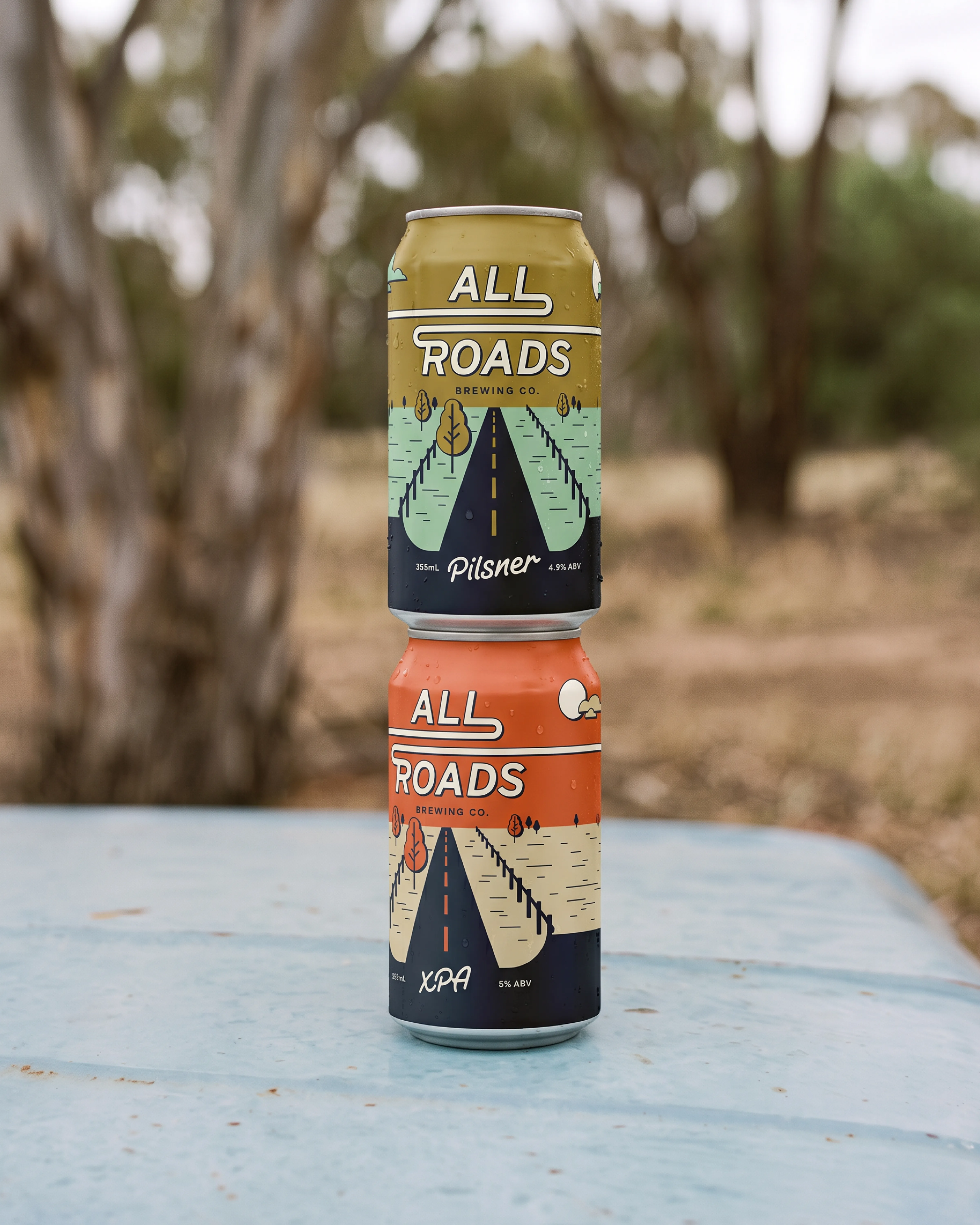 All Roads Brewing Co. Pilsner and XPA cans stacked outdoors