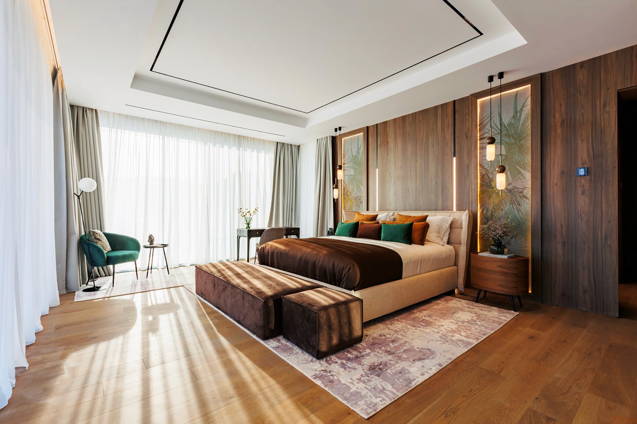 Villa Trio master bedroom with warm wood wall panels, pendant bedside lighting, and full-height curtains