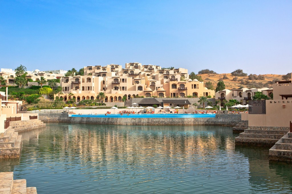 the Cove Rotana Resort features luxurious villas and pools set against a serene beachfront landscape.