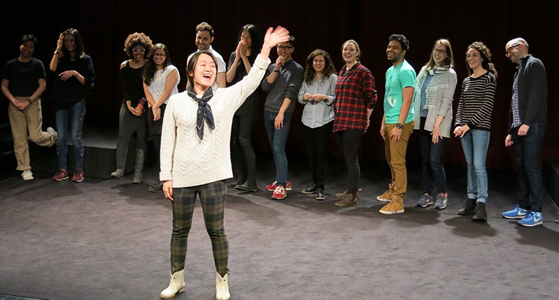 people at theater with woman in front