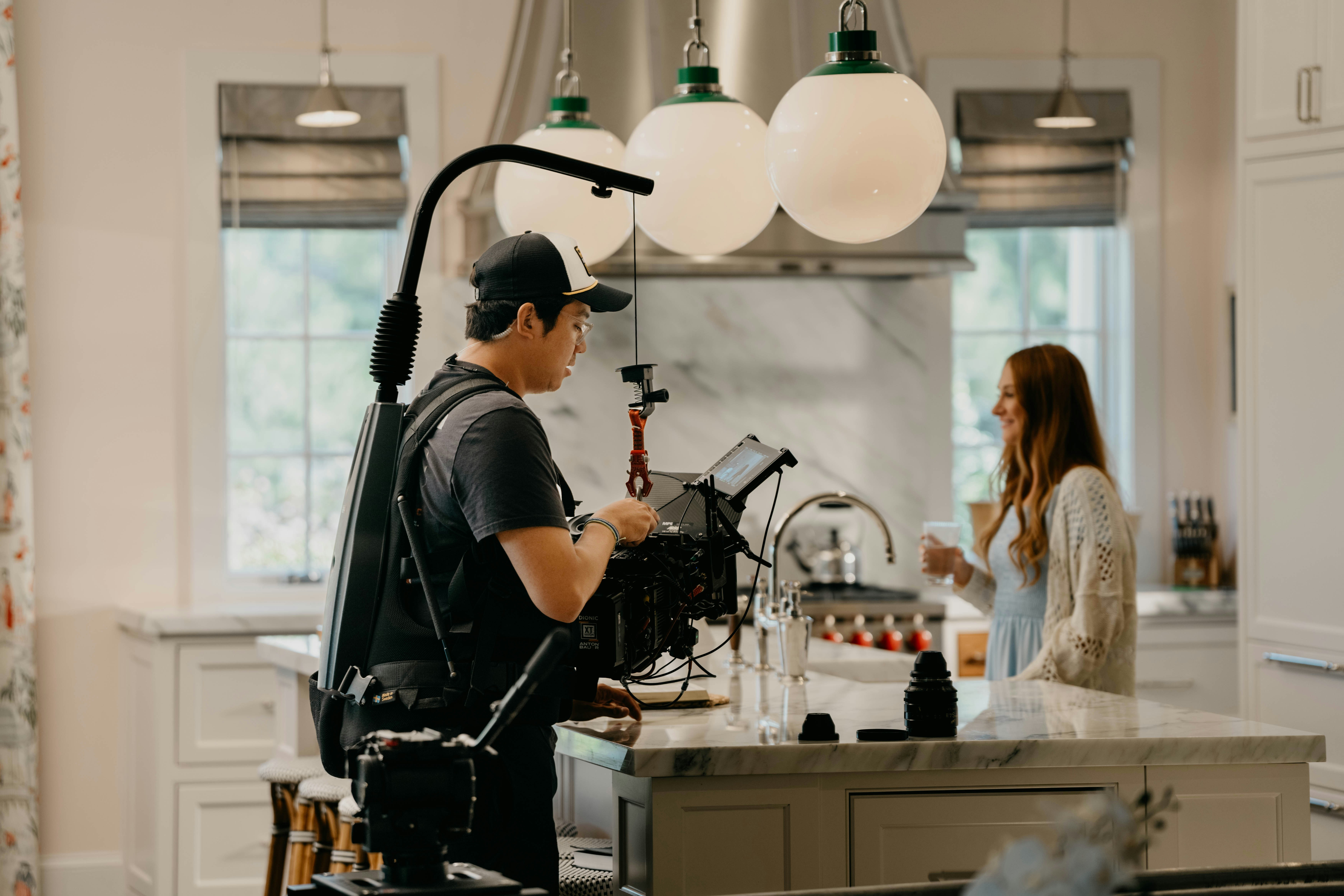 a man standing in a kitchen next to a woman