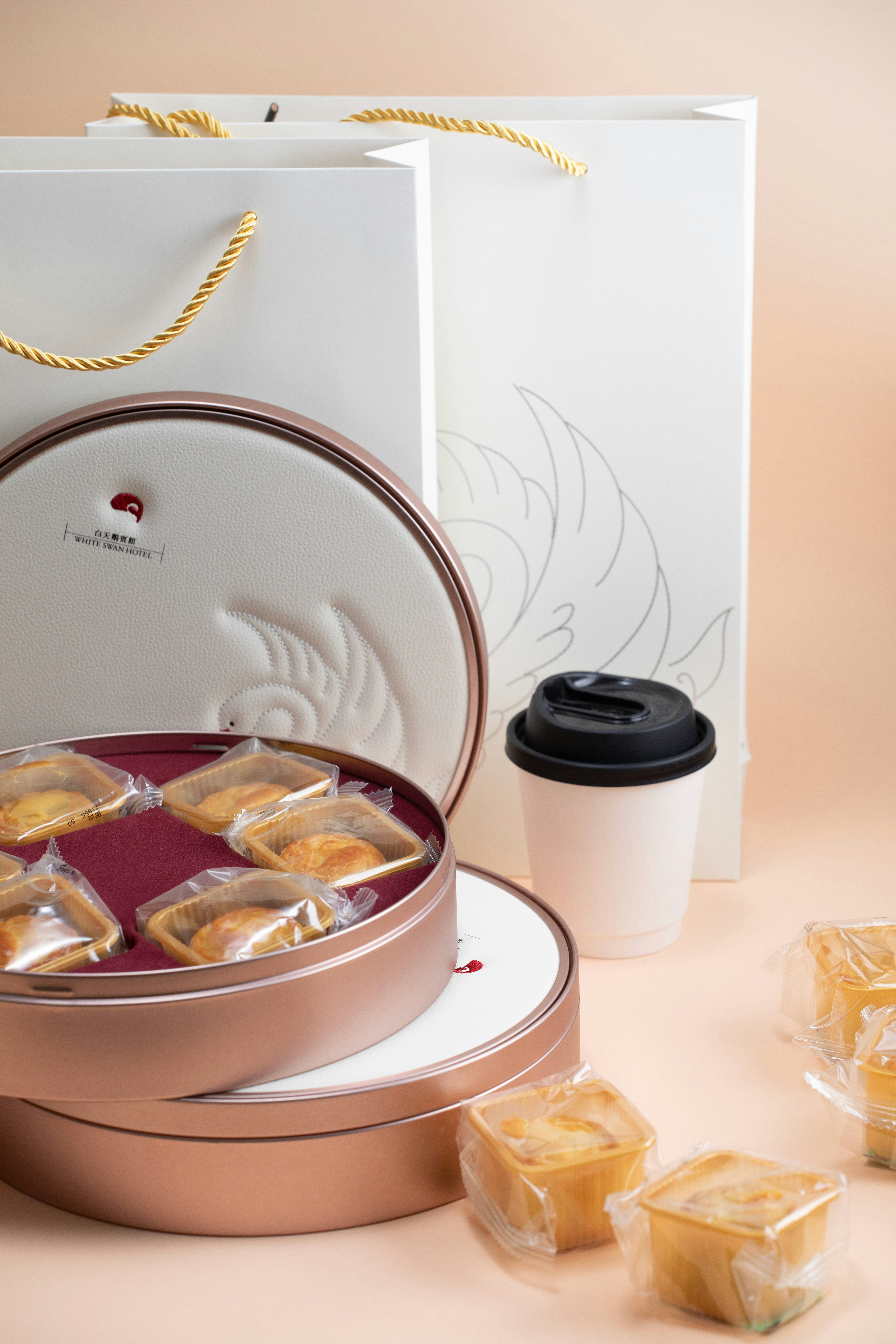 Gourmet pastries and coffee in elegant gift packaging.
