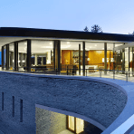 Exterior view of a modern luxury longevity clinic at dusk