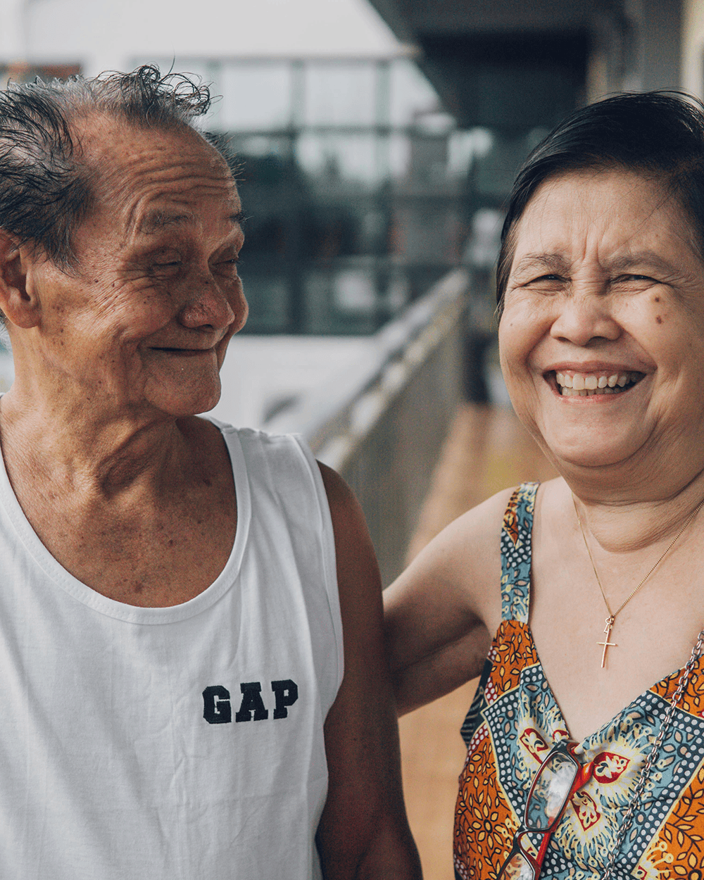 An elderly man and an elderly woman smiling