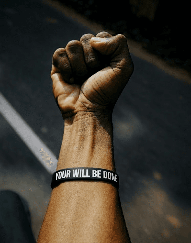woman in gray knit sweater covering her face with her hand