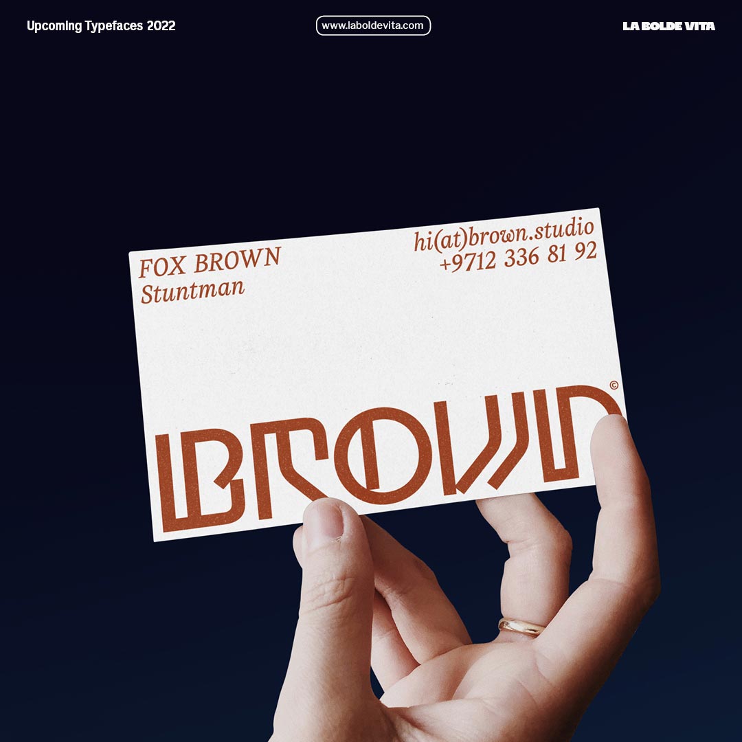 photo of a business card with a big logo set in Grotunda in decent brown on white paper