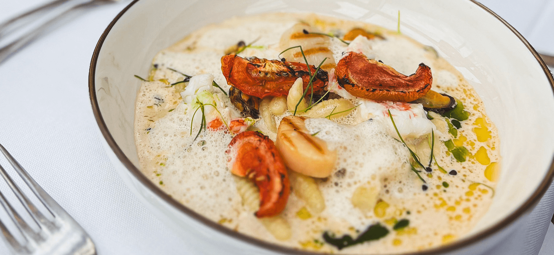 Shrimp boiling in a pot of water with bubbles, captured in a black and white photo, showcasing seafood cooking method.