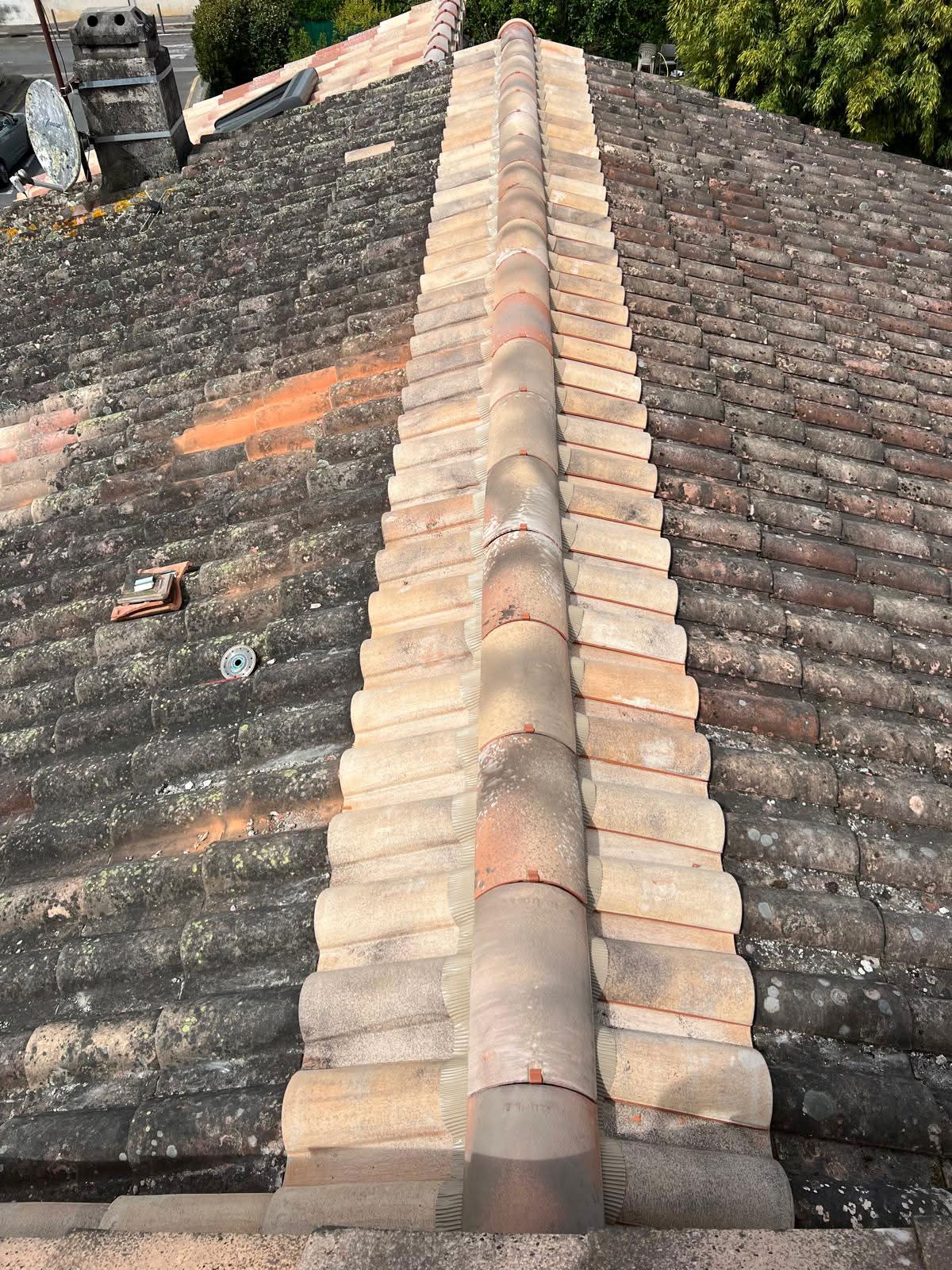 a man in a yellow shirt is working on a roof