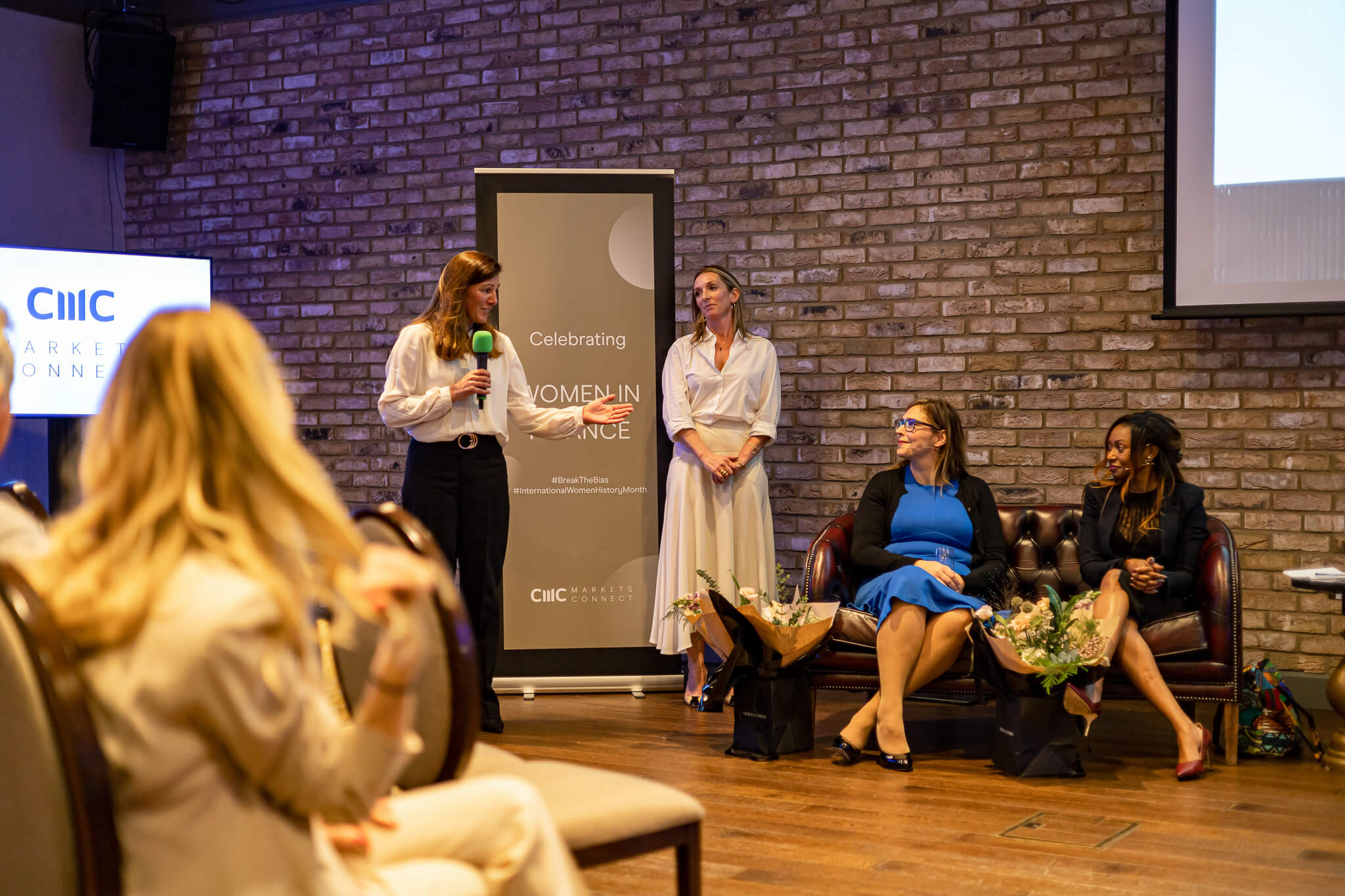 Speaker addressing the audience during a women in finance networking and business event