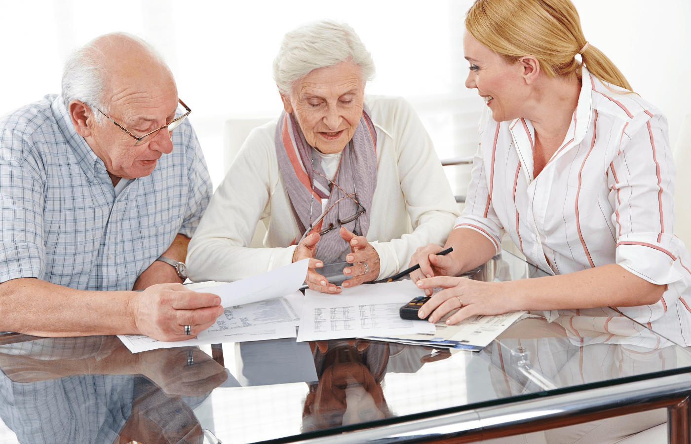 Senior couple getting financial consultation from insurance saleswoman