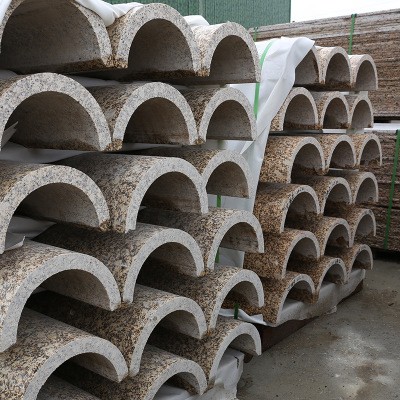 Finished stone arcs neatly stacked, produced by the Automatic Arc-Slab Trimming Machine, showcasing consistent quality and precision.