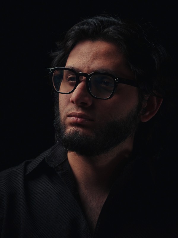 headshot of razi in dark moody setting