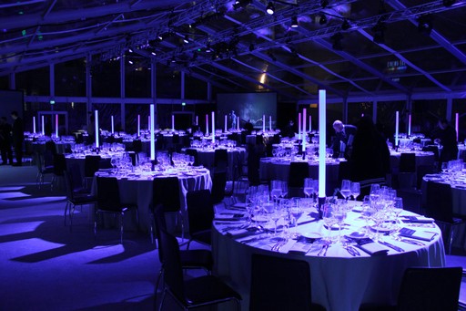 Sophisticated lighting and sound setup creating a vibrant atmosphere at a corporate gathering.