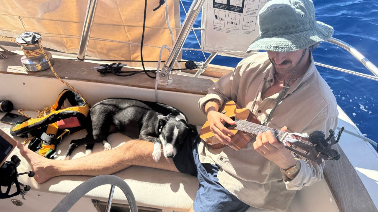 Xander and his dog Phoebe on his sailboat