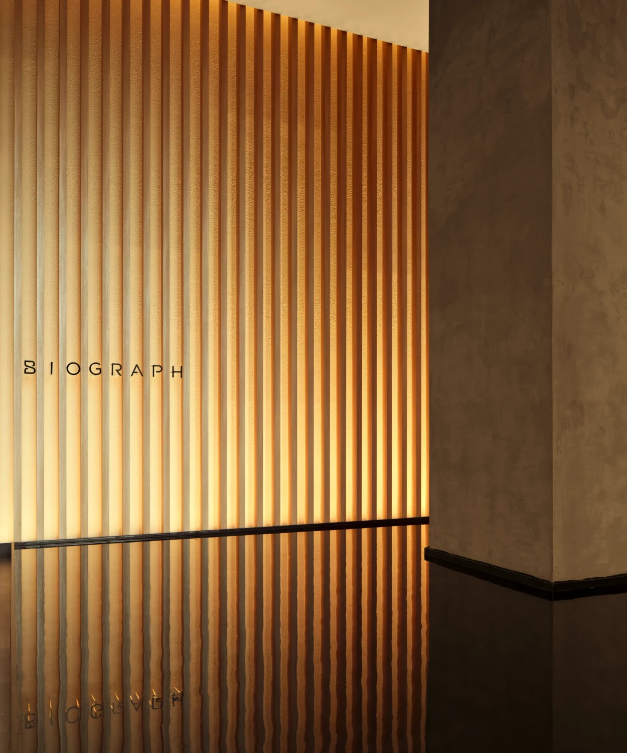 Architectural wood panel design inside Biograph NYC longevity health clinic, blending modern aesthetics with private healthcare.
