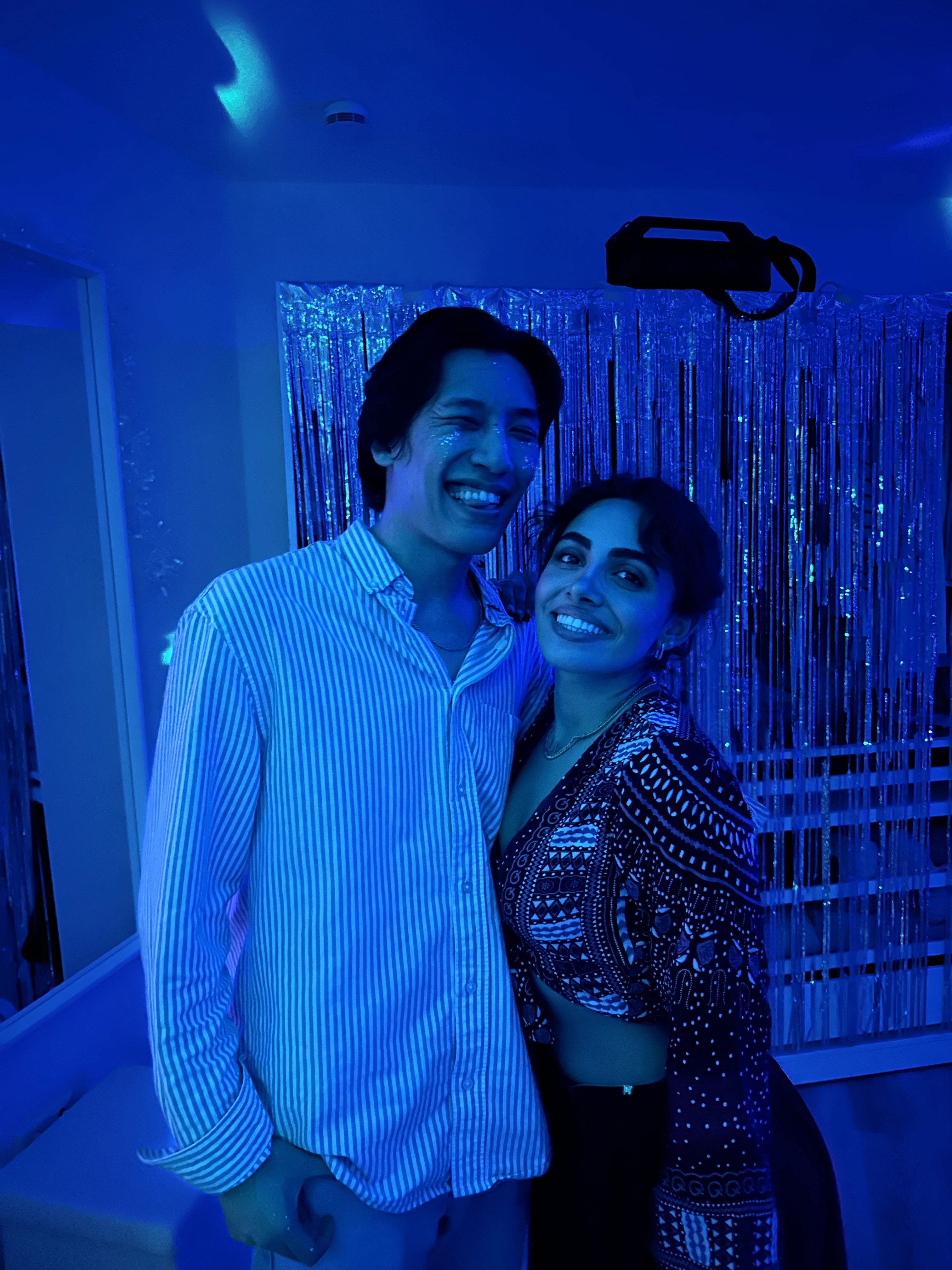 Person sitting on a ledge overlooking New York City skyline
