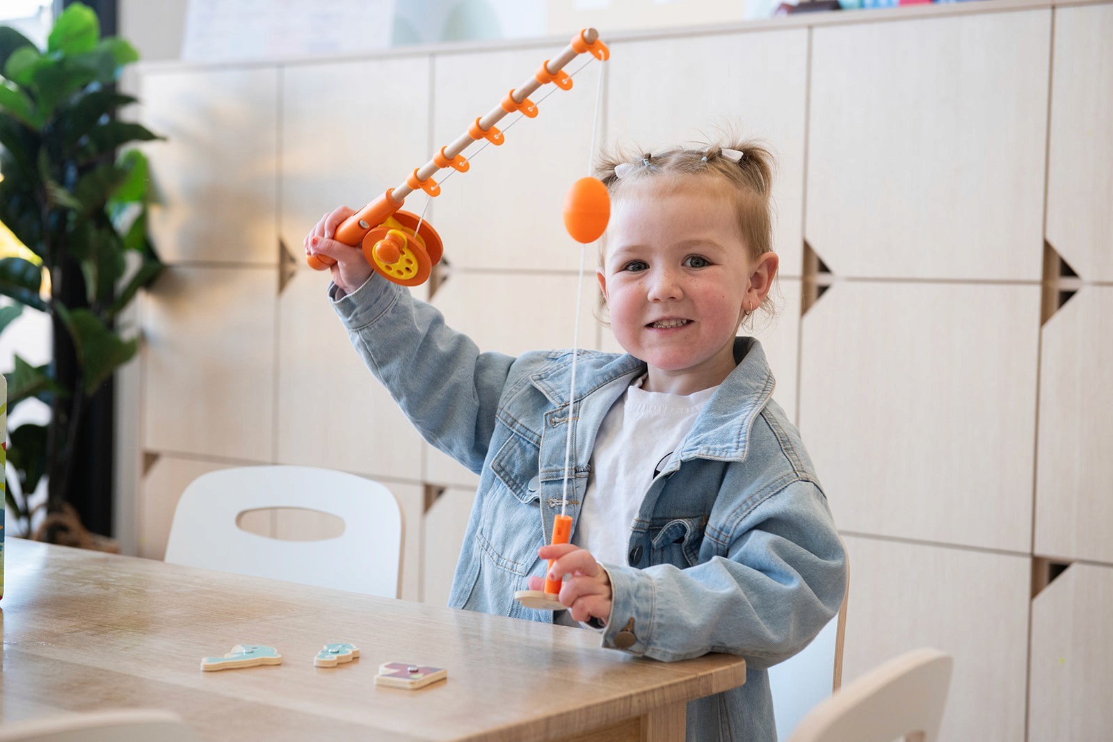 Close-up of a dark green leaf showing its textured surface and central vein against a muted background.