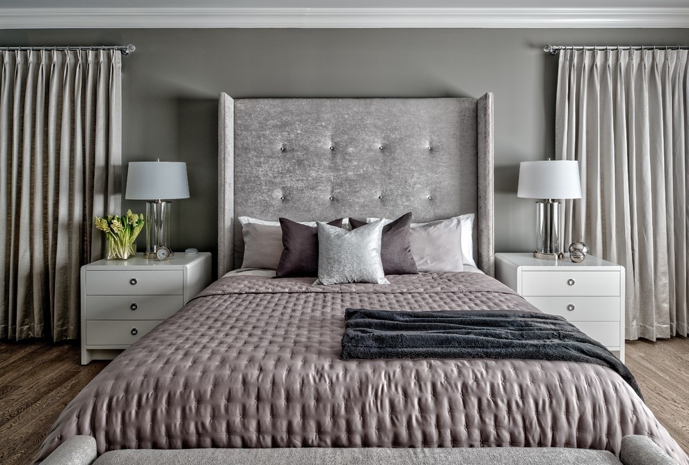 Image of Luxurious primary suite with tufted headboard, plush bedding, and elegant window coverings by KHD Homes.
