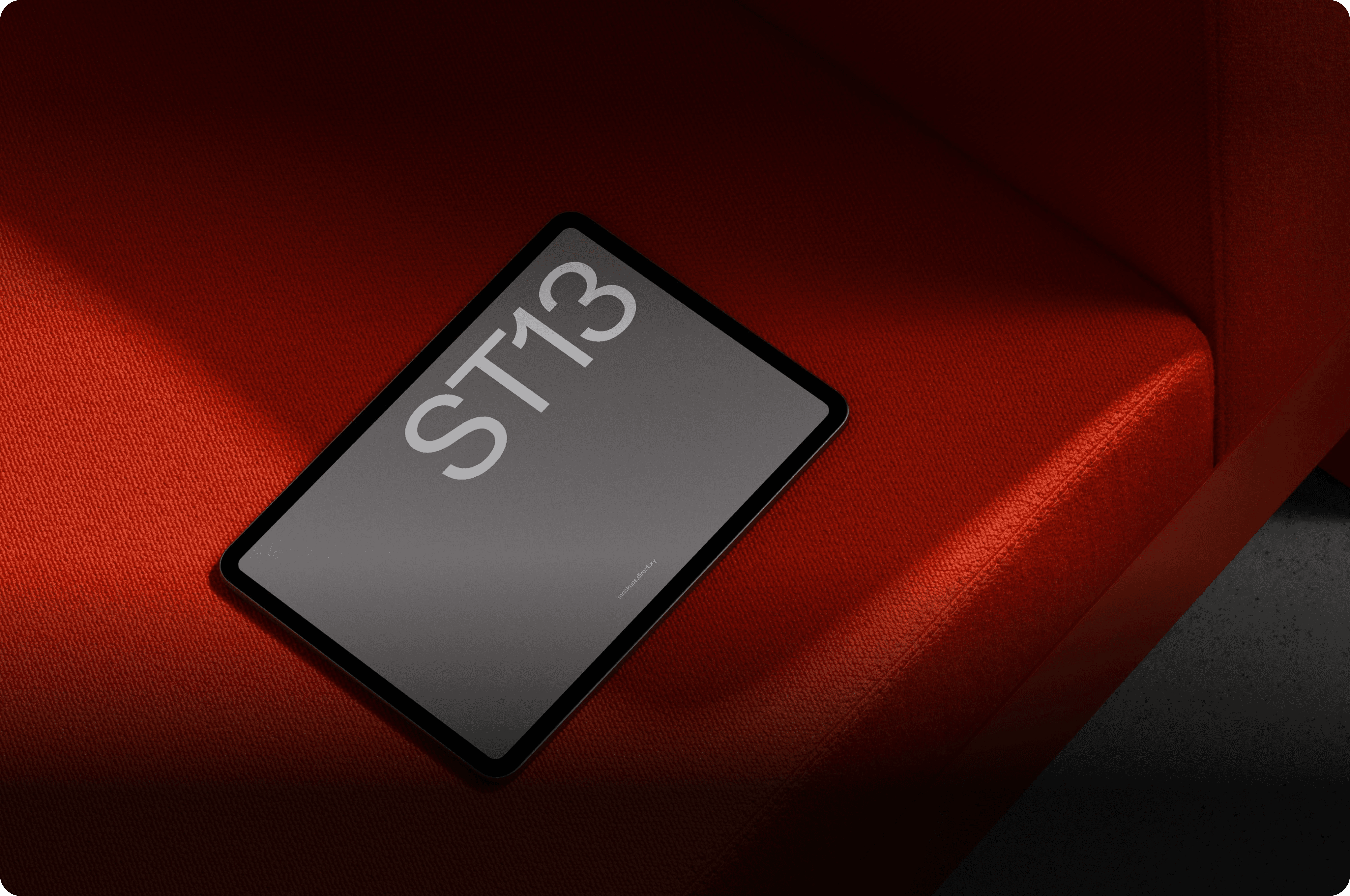 Professional tablet screen mockup on a vibrant red fabric background for digital