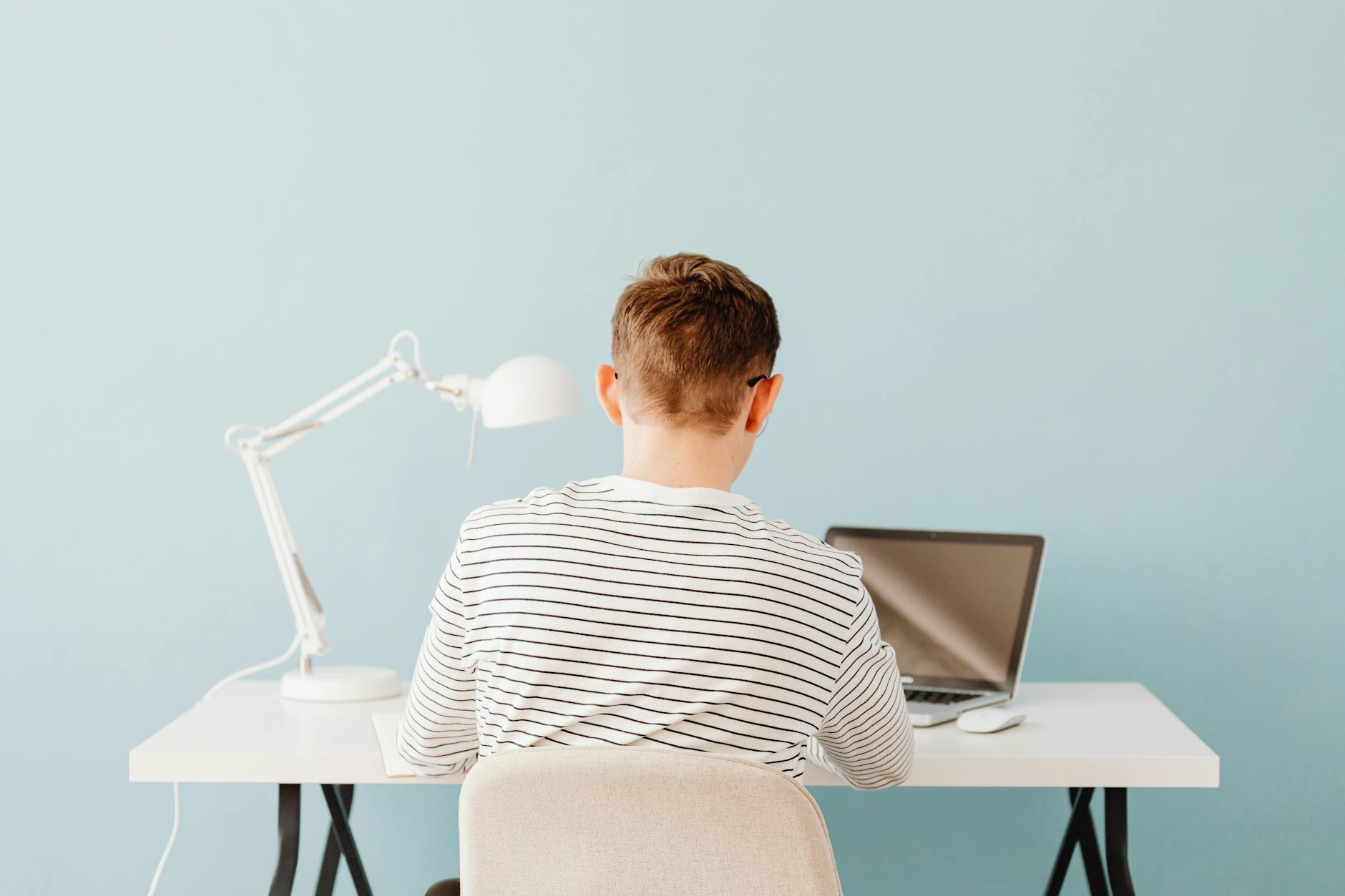 High school students engaged in a lively debate while their teacher moderates from the side of the classroom.