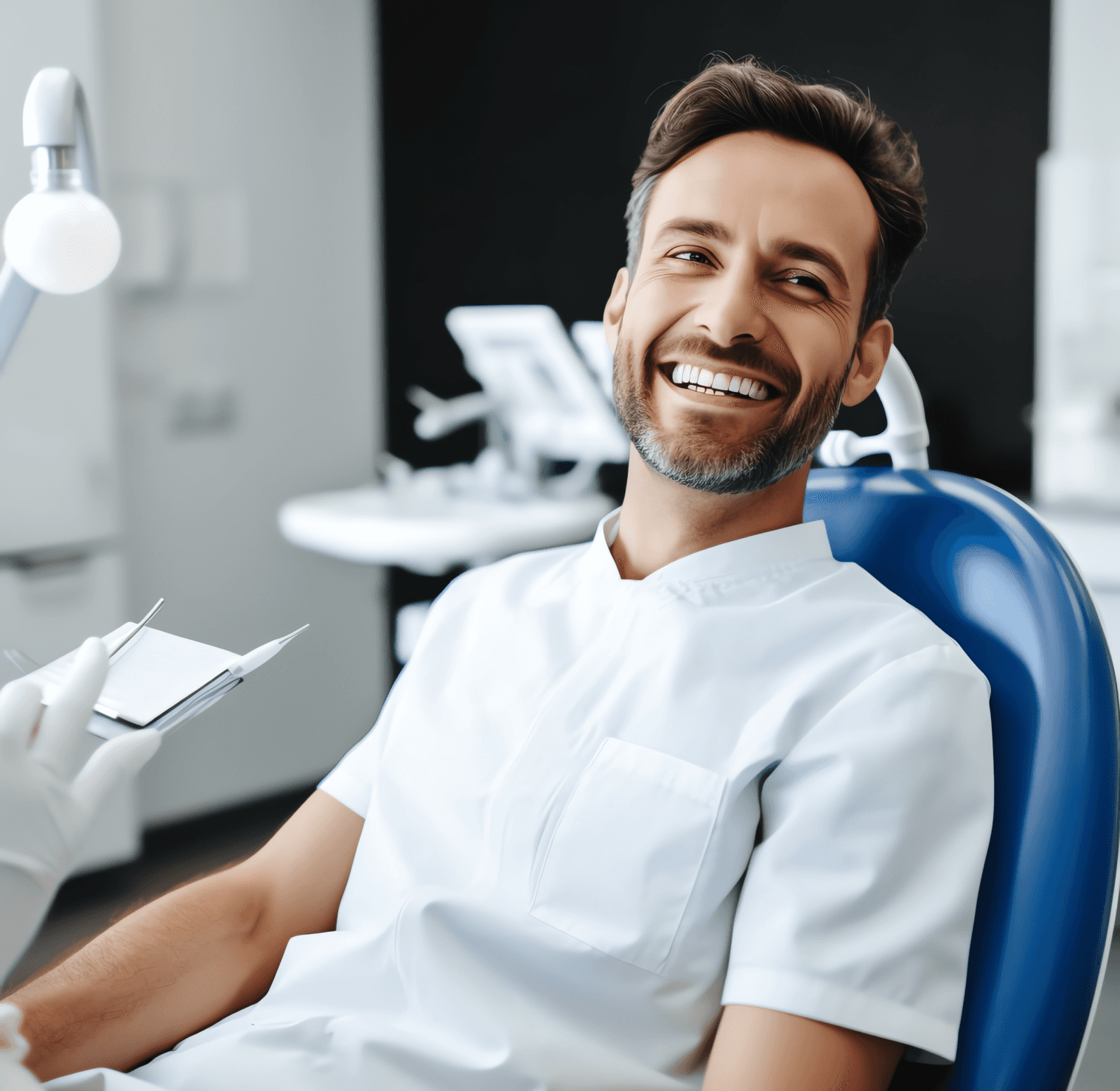 A smiling dentist sitting in a dental chair, ready to assist patients in achieving a healthy and confident smile.