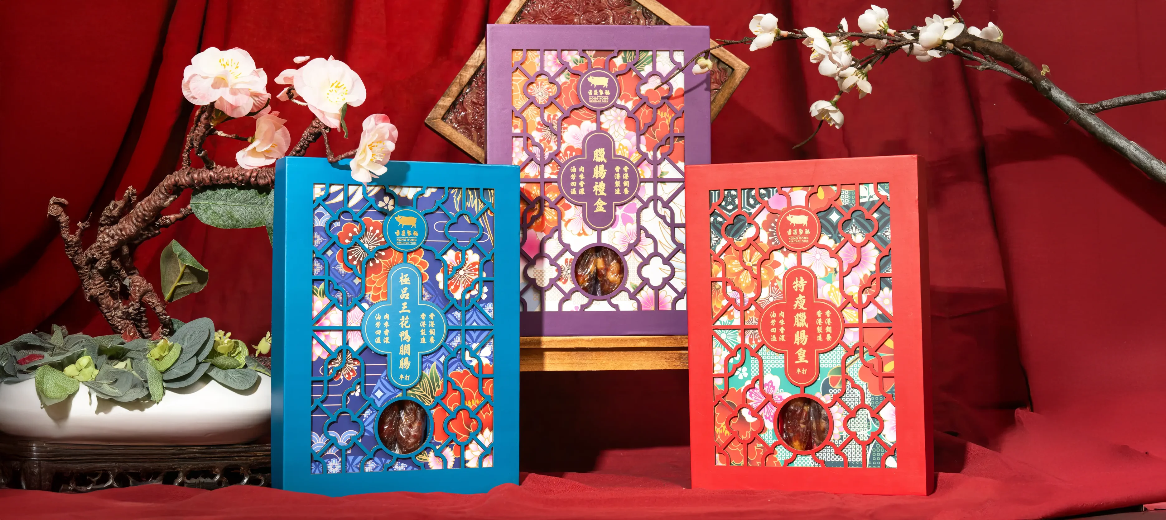 HK Heritage Pork Lap Cheong gift box packaging hero – premium boxes with traditional peonies, plum blossoms, and vibrant festive colours in modern presentation by Teatime Studio.