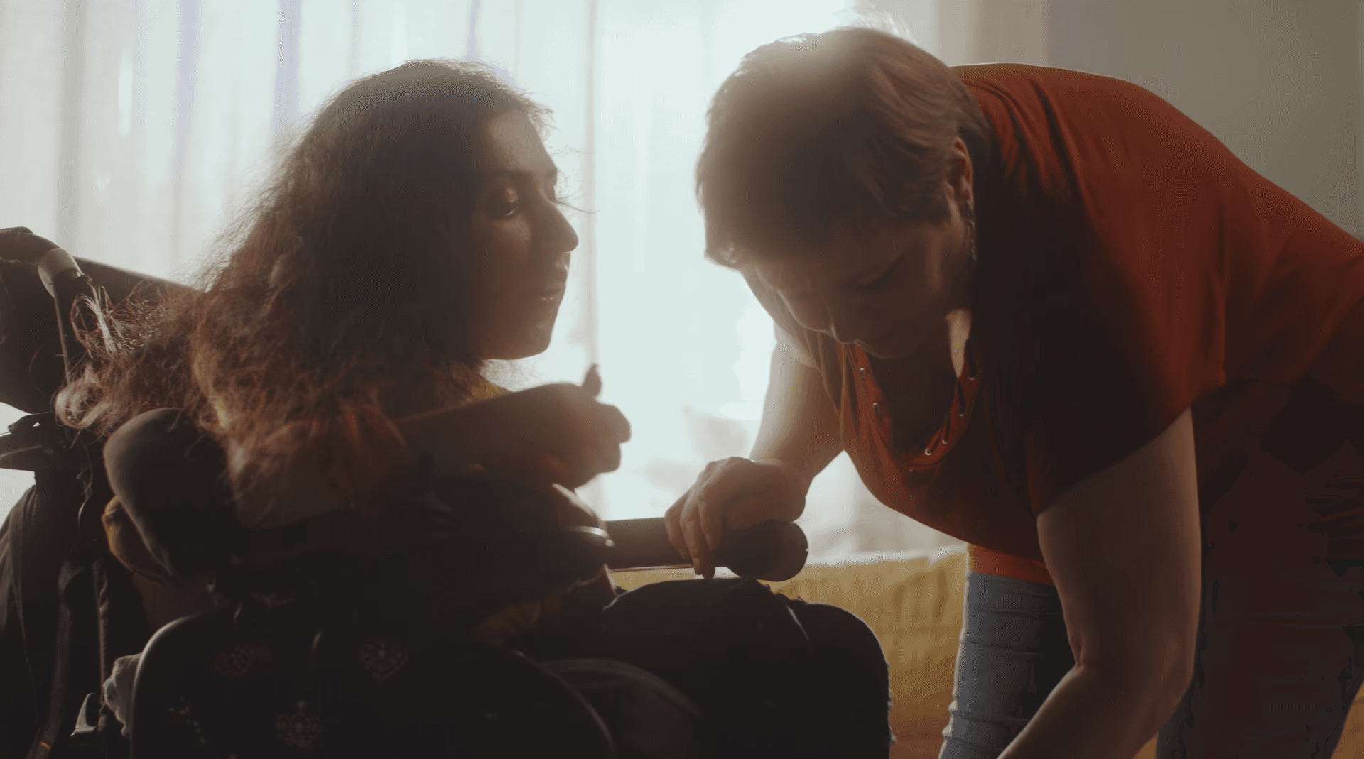 Someone helping an individual with a disability.