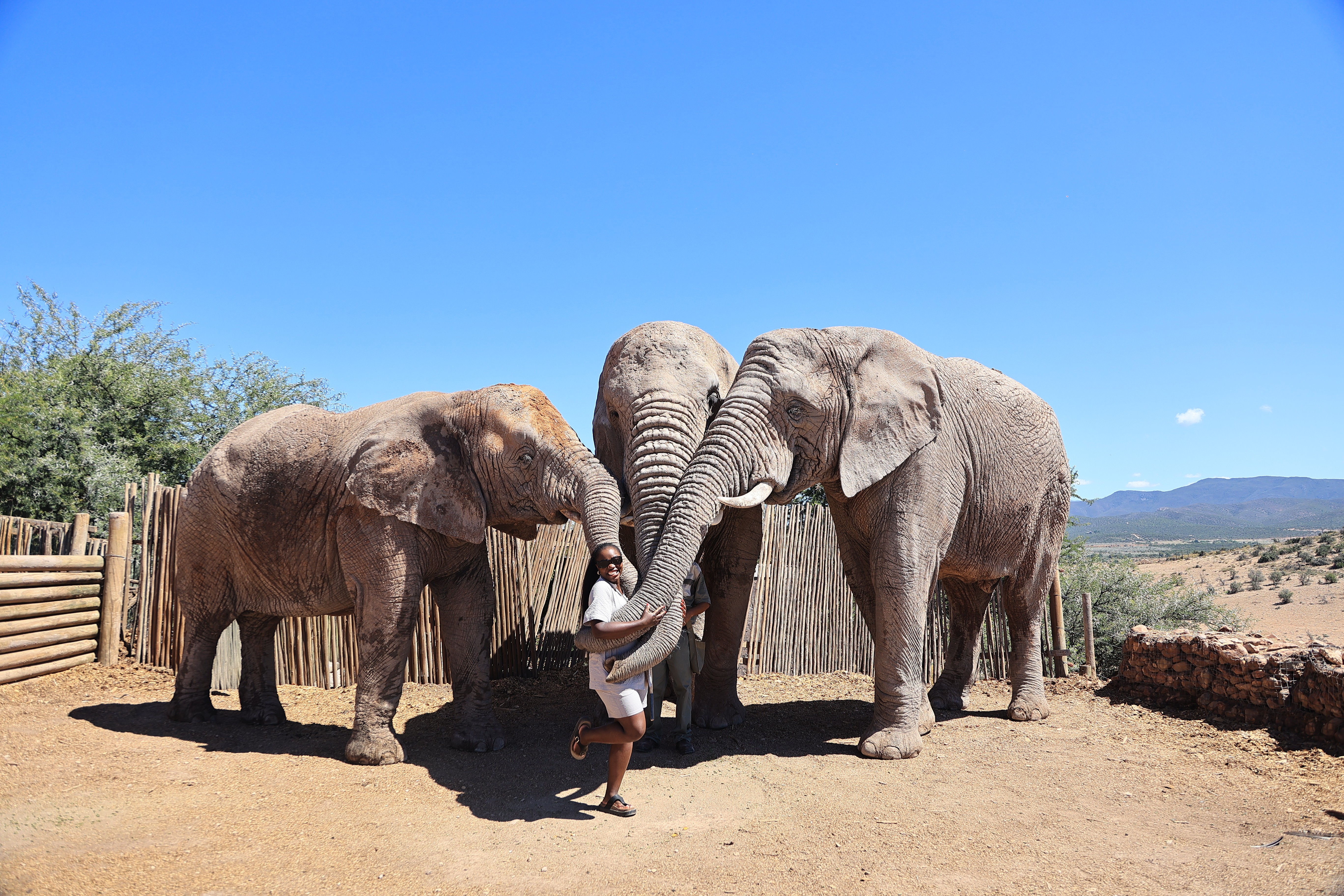 Mary Consolata Namagambe riding side saddle on a motorbike in Uganda, Africa