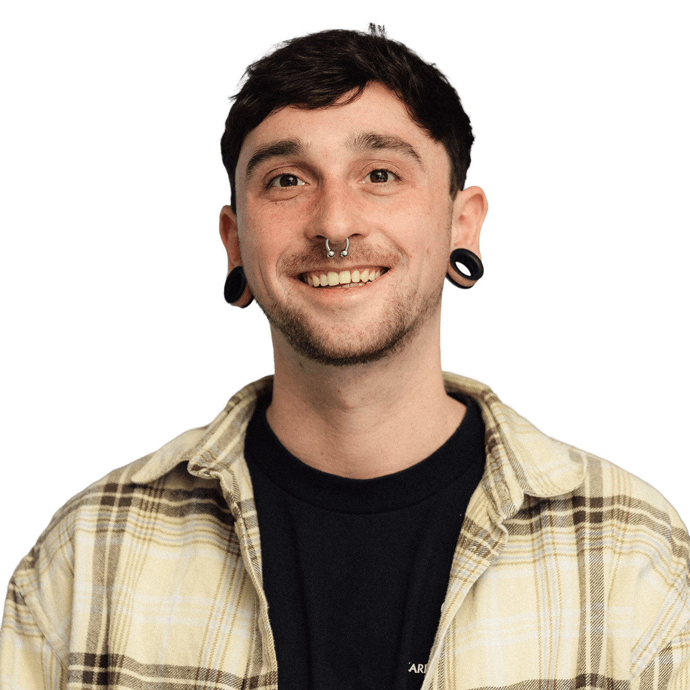 Portrait of the designer smiling in a casual plaid shirt.