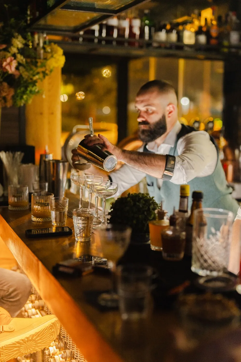 A phone, pad, and pen sit on a wooden desk.