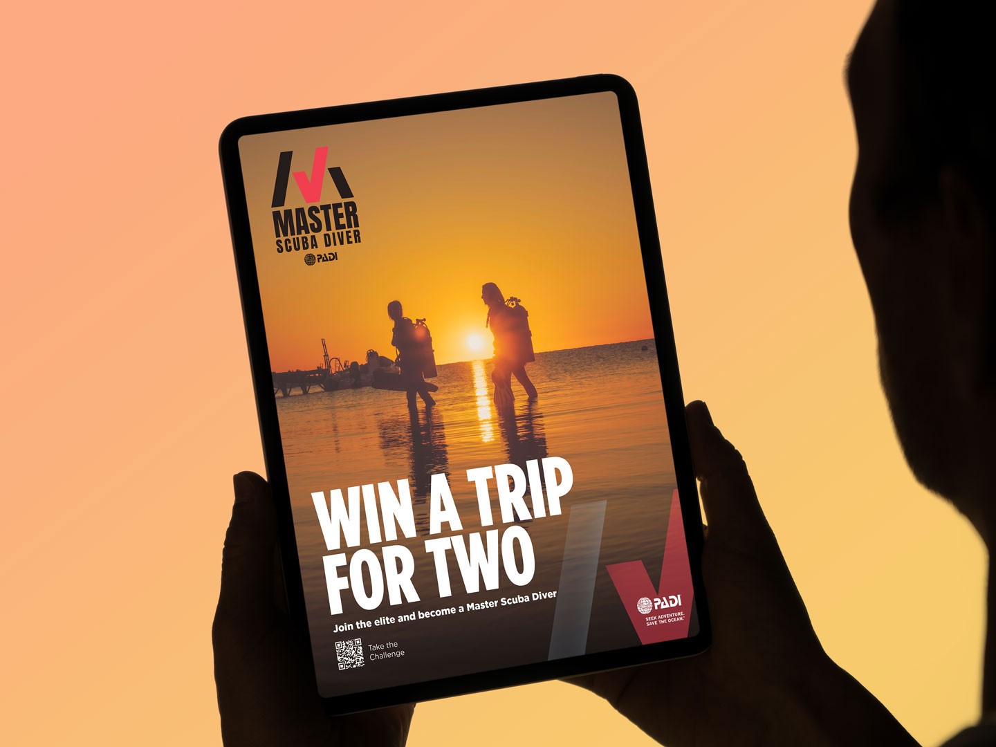 Lifestyle mockup of a Master Scuba Diver campaign ad featuring sunset dive imagery, travel incentives, and achievement-focused branding displayed on a tablet screen.