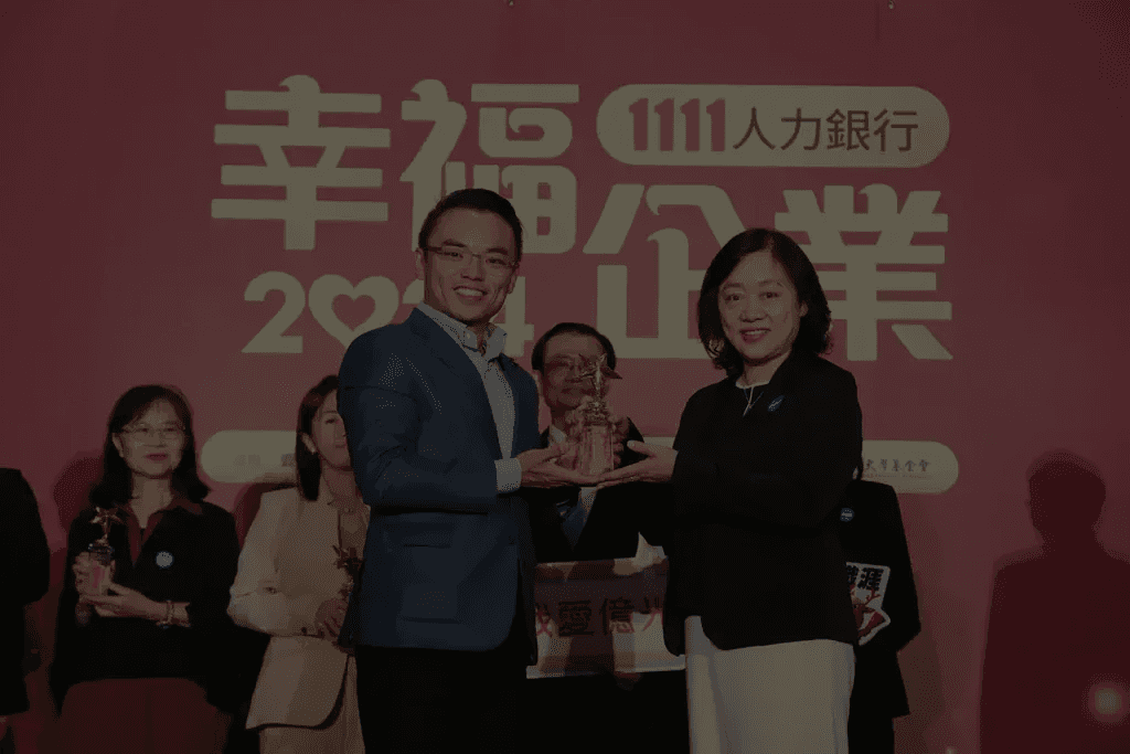 Modern kitchen with a wooden dining table, white chairs, and a hanging light fixture above.