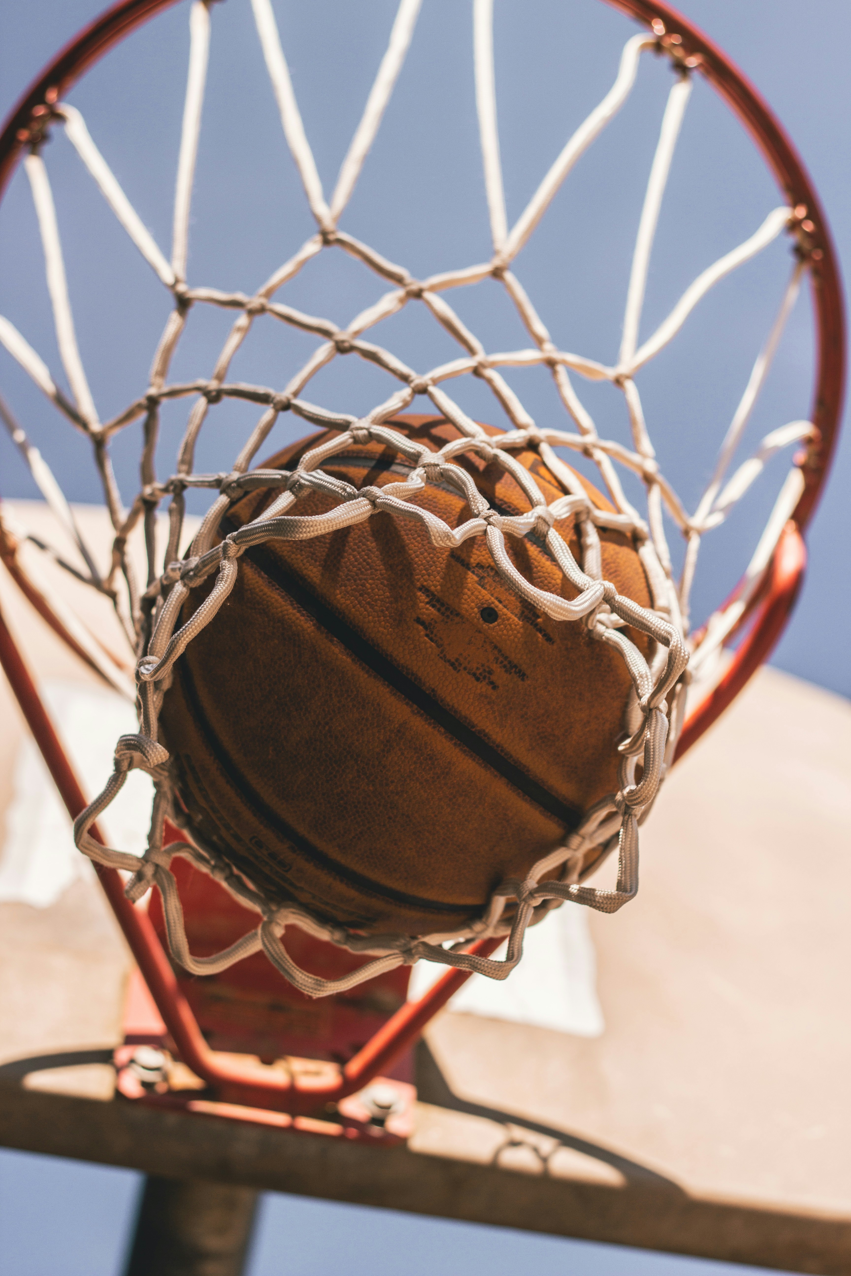 Basketball swishing through the hoop during a game.